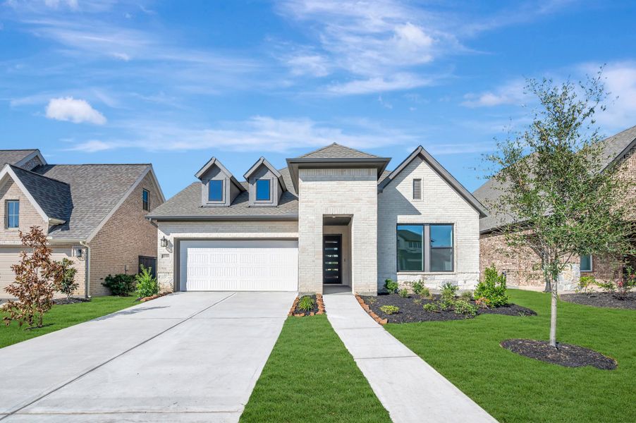 Front exterior of a new home in Riceland - Enclave Collection, Mont Belvieu, TX, highlighting curb appeal (Image 1). Front exterior of a new home in Riceland - Enclave Collection, Mont Belvieu, TX, highlighting curb appeal (Image 1).