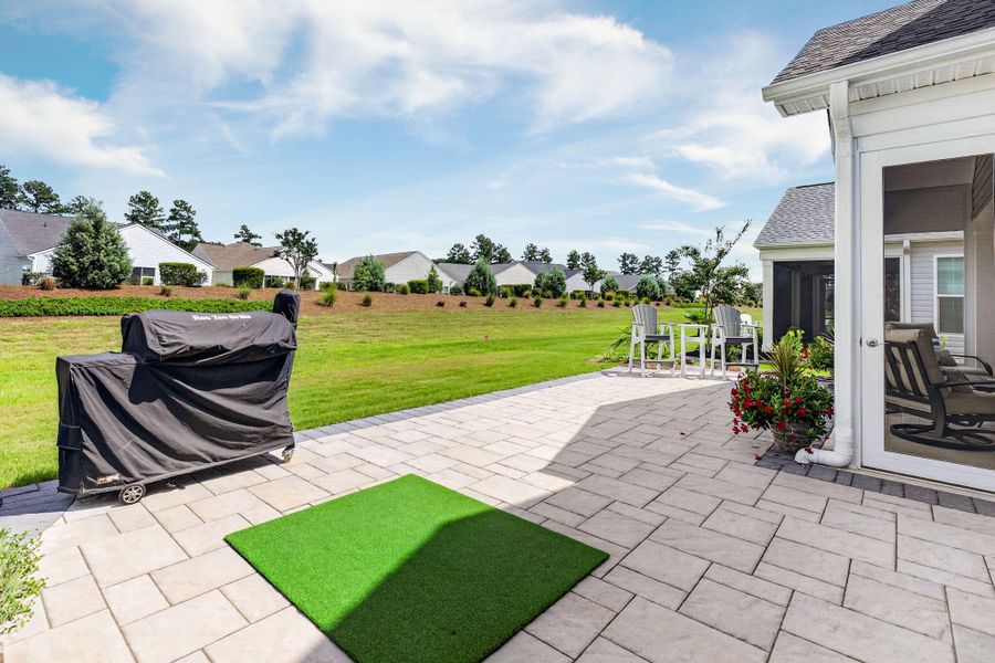 Exterior details and patio area of a home in K. Hovnanian's® Four Seasons at Lakes of Cane Bay, Summerville (Image 31).