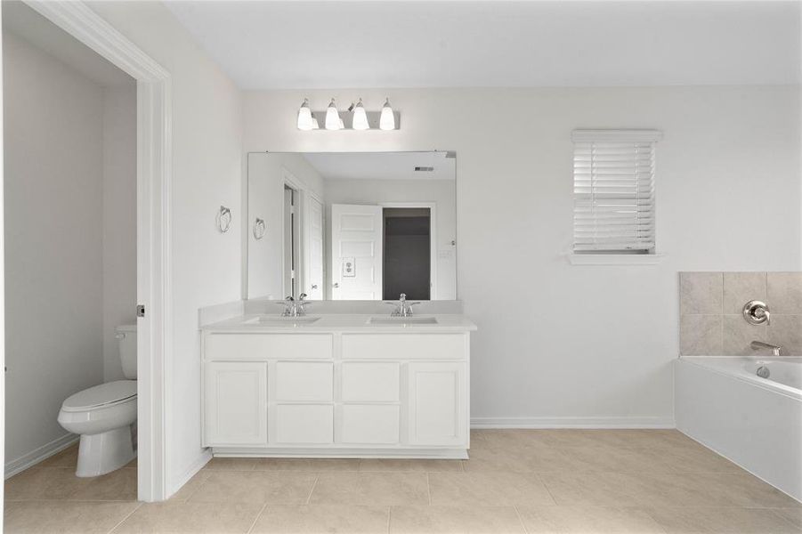 This primary bathroom is definitely move-in ready! Featuring a walk-in shower with tile surround, separate garden tub for soaking after a long day with custom tile detailing, white stained cabinets with light countertops, high ceilings, neutral paint, sleek and modern finishes.