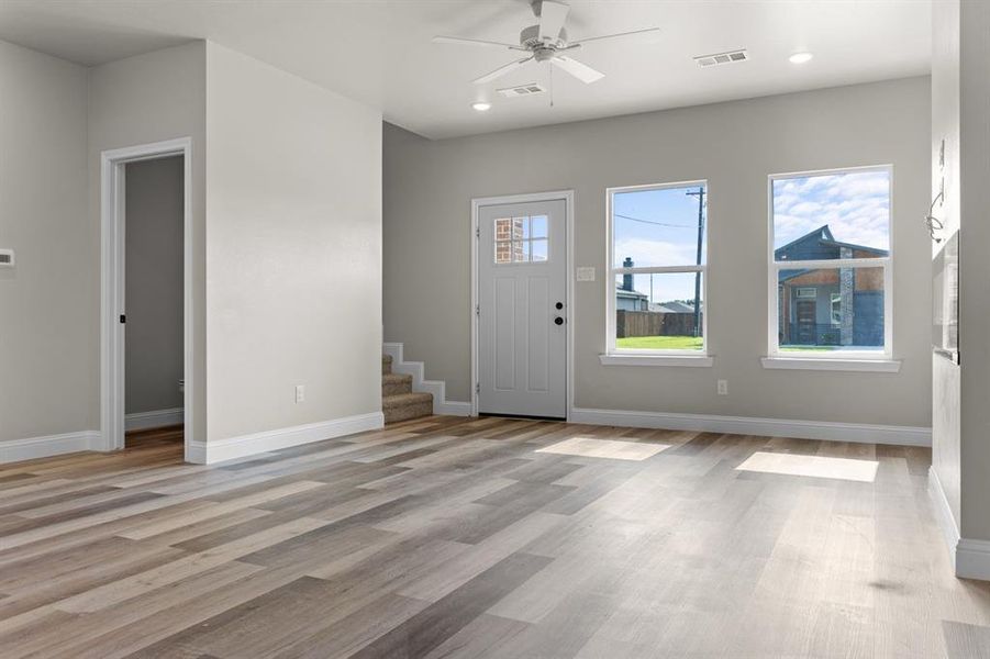 Entryway with light wood-style flooring, a ceiling fan, stairway, baseboards, and recessed lighting Entryway with light wood-style flooring, a ceiling fan, stairway, baseboards, and recessed lighting