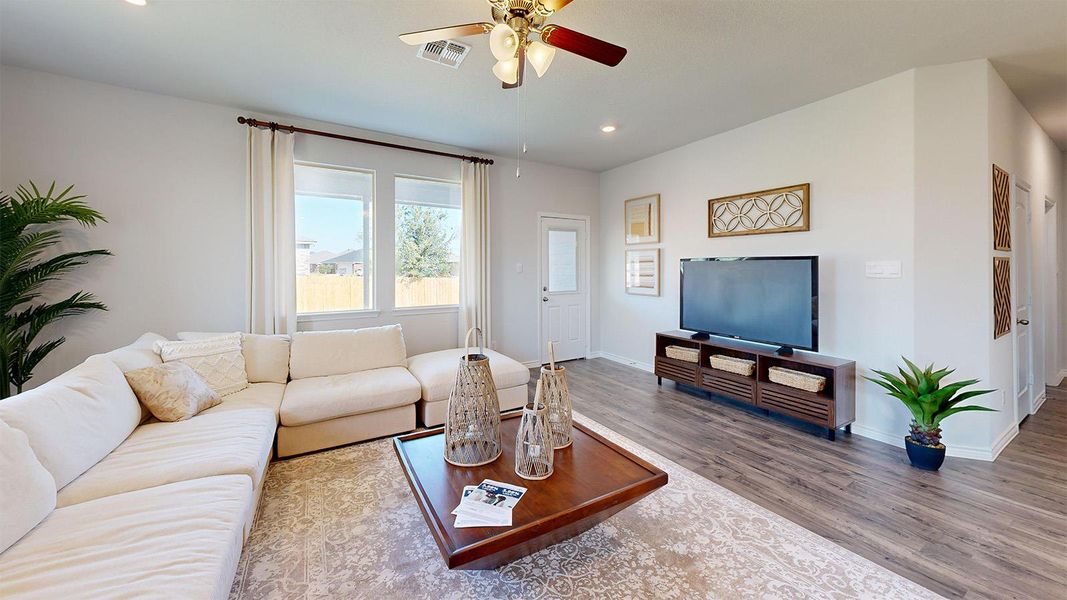 Living area with ceiling fan, recessed lighting, and dark wood finished floors Living area with ceiling fan, recessed lighting, and dark wood finished floors