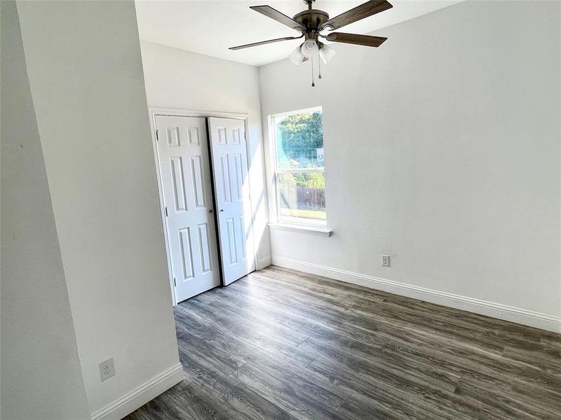 Unfurnished bedroom featuring a closet, ceiling fan, and dark hardwood / wood-style floors