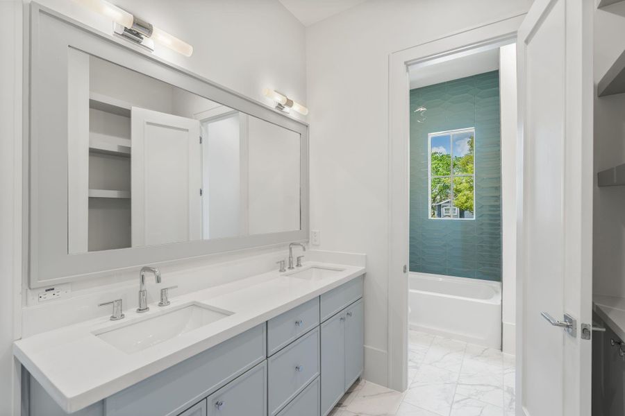 A closer look highlights clean cabinetry lines, polished hardware, and bright lighting that enhances the crisp, contemporary design.