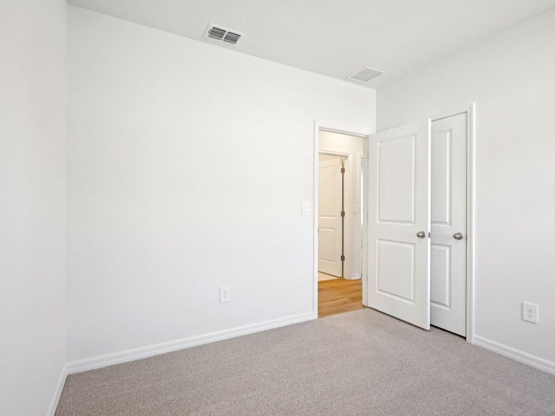 Spacious, unfurnished interior of a new home in The Grove at Stuart Crossing - Premier Series, Bartow (Image 12).