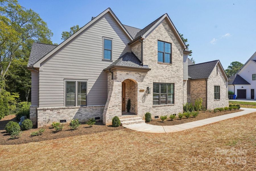 Front exterior of a new home in , Huntersville, NC, highlighting curb appeal (Image 1).