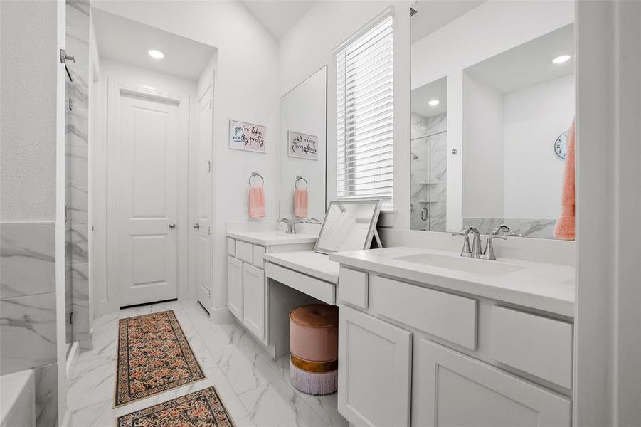 Primary bathroom with separate vanities and makeready area Primary bathroom with separate vanities and makeready area