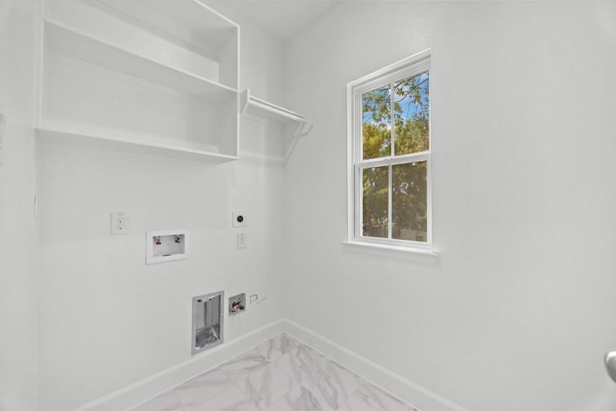 A laundry room you’ll actually want to use. Built-in shelving, hanging space, and even a window to make chores feel just a little lighter.