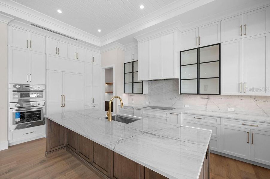 Kitchen with Oversized Island and Custom Solid Wood Cabinetry Throughout.