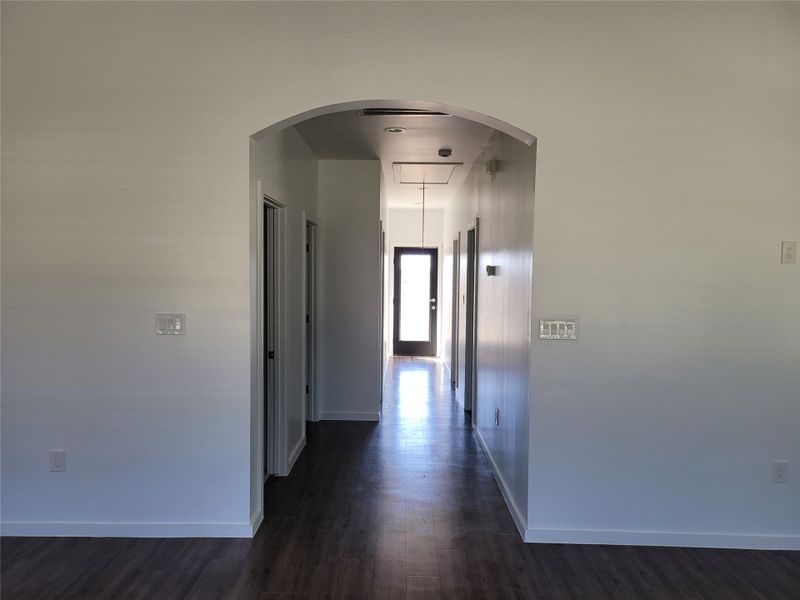 Hall with dark wood-style flooring and arched walkways