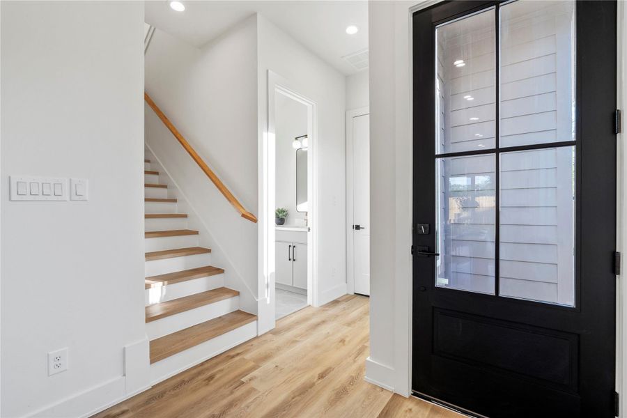 A sleek and space-efficient half bath conveniently tucked under the staircase, featuring modern finishes and designer touches. A sleek and space-efficient half bath conveniently tucked under the staircase, featuring modern finishes and designer touches.