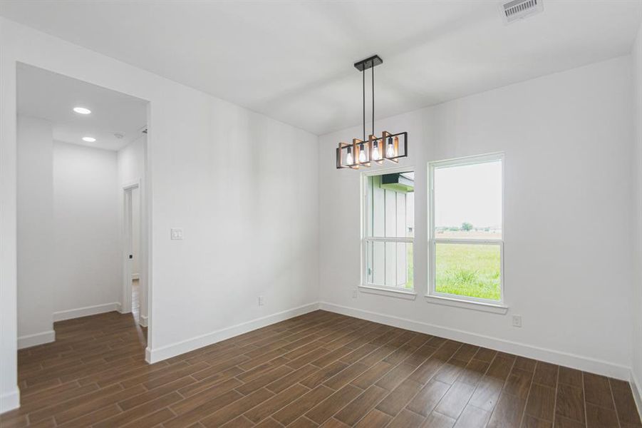 Dining Area with modern lighting and natural light from the oversized windows.