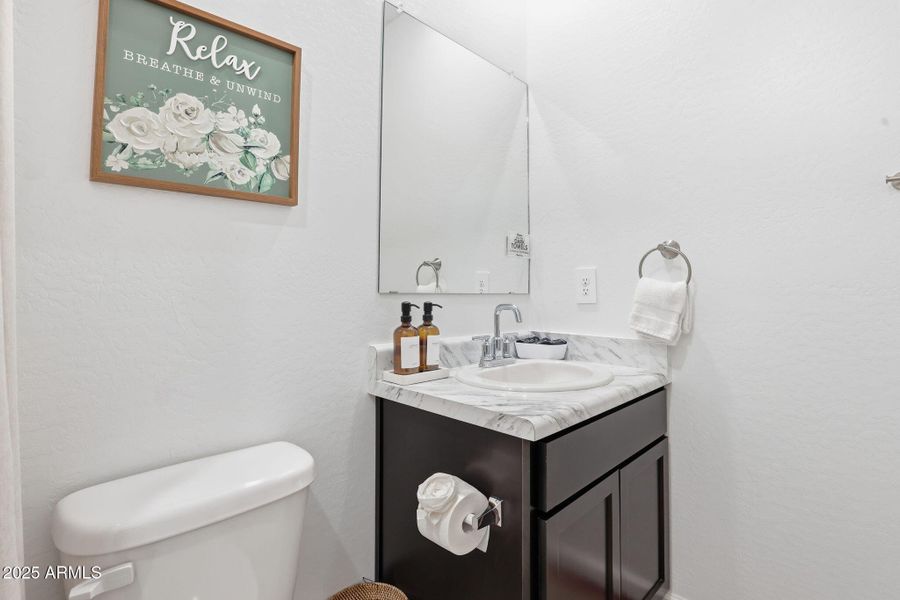 Bathroom vanity has storage under the si