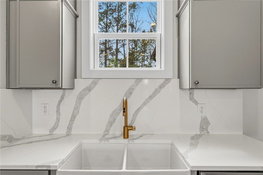 This kitchen showcases a modern sink with a sleek