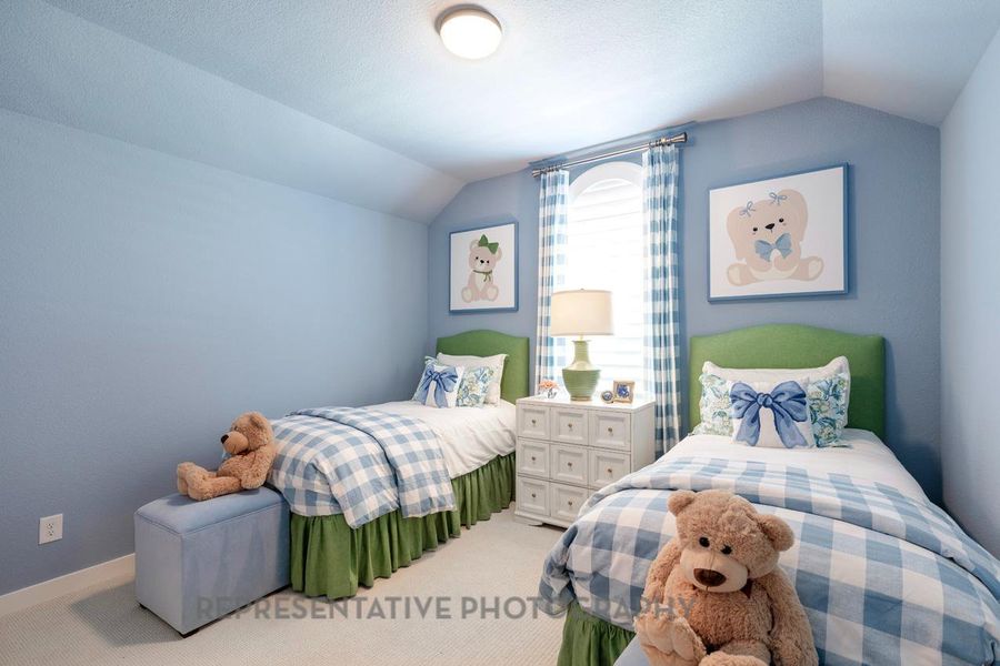 Carpeted bedroom featuring lofted ceiling and baseboards