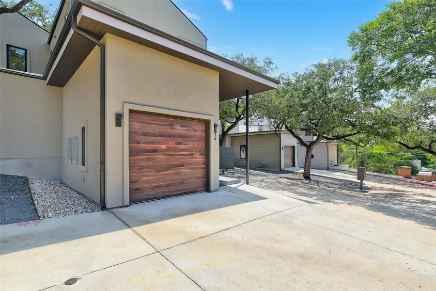 Garage featuring concrete driveway