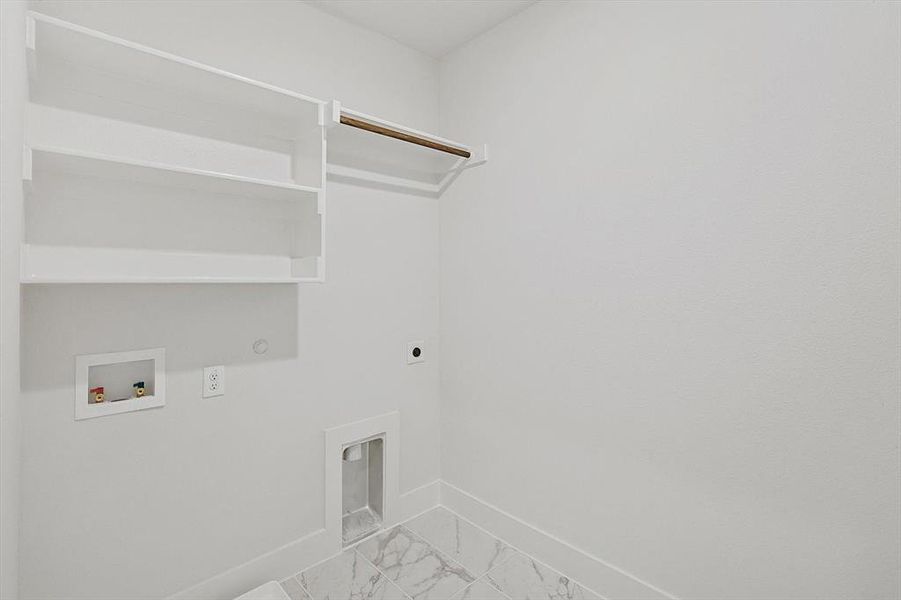 Laundry area with marble finish floor, baseboards, hookup for an electric dryer, hookup for a washing machine, and laundry area