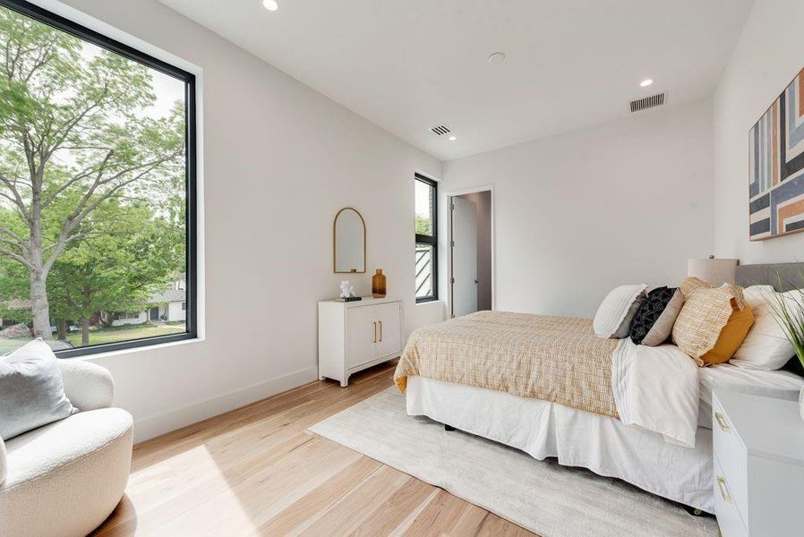 The second floor bedroom/guest suite offers a quiet and comfortable retreat overlooking huge yard and massive trees.