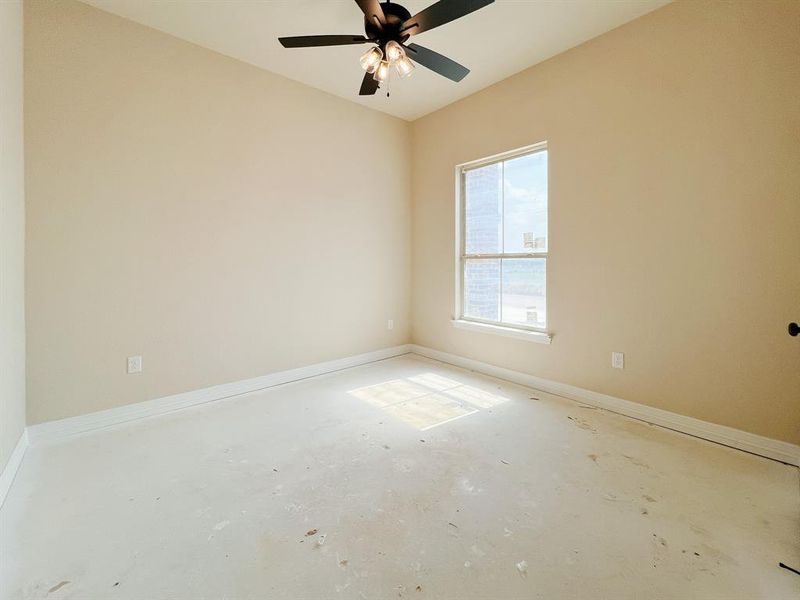 Unfurnished room with unfinished concrete flooring and ceiling fan Unfurnished room with unfinished concrete flooring and ceiling fan