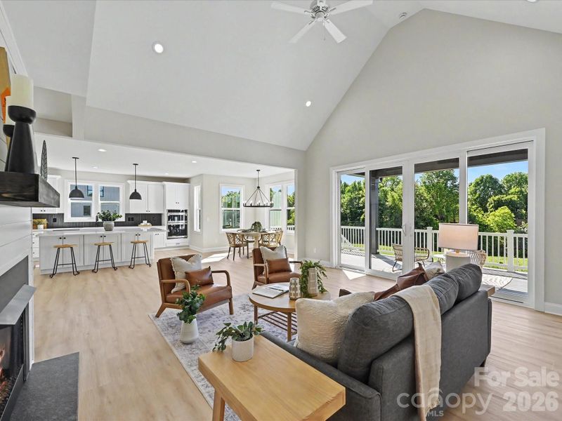 Vaulted ceilings, expansive windows, and an open-concept design fill the stunning great room with natural light while seamlessly connecting the living, dining, and kitchen spaces for effortless entertaining.
