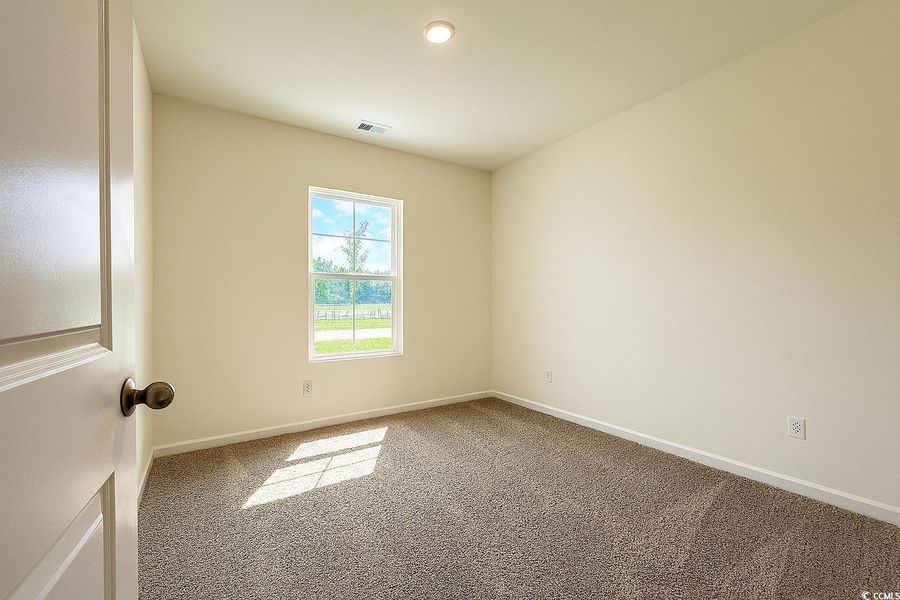 Spare room with carpet floors and baseboards