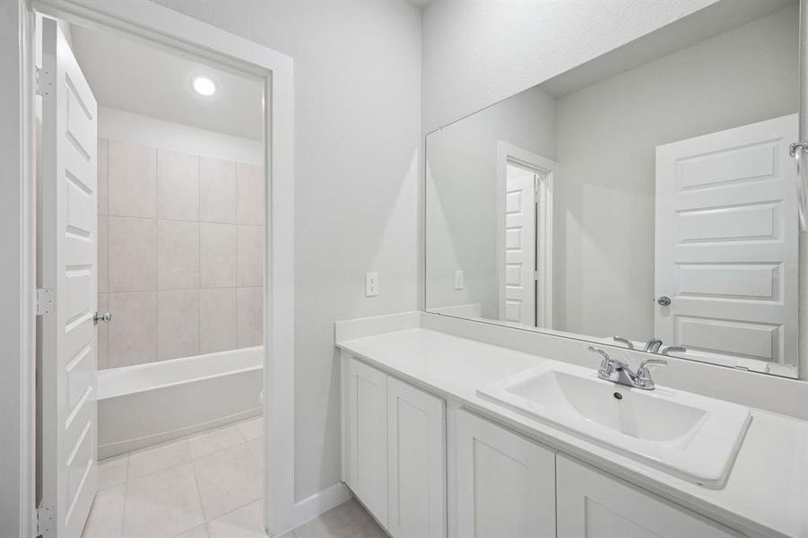 Bathroom in the Masters home plan by Trophy Signature Homes – REPRESENTATIVE PHOTO