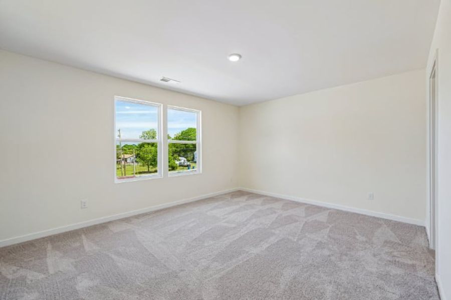 A room with a window and a carpet.