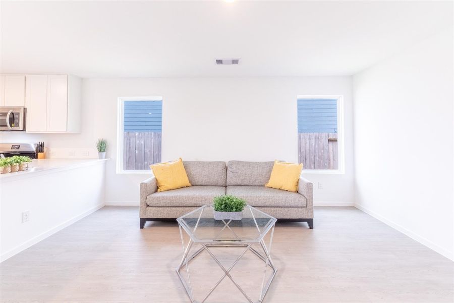 The bright and open living area features large windows that fill the space with natural light. The bright and open living area features large windows that fill the space with natural light.
