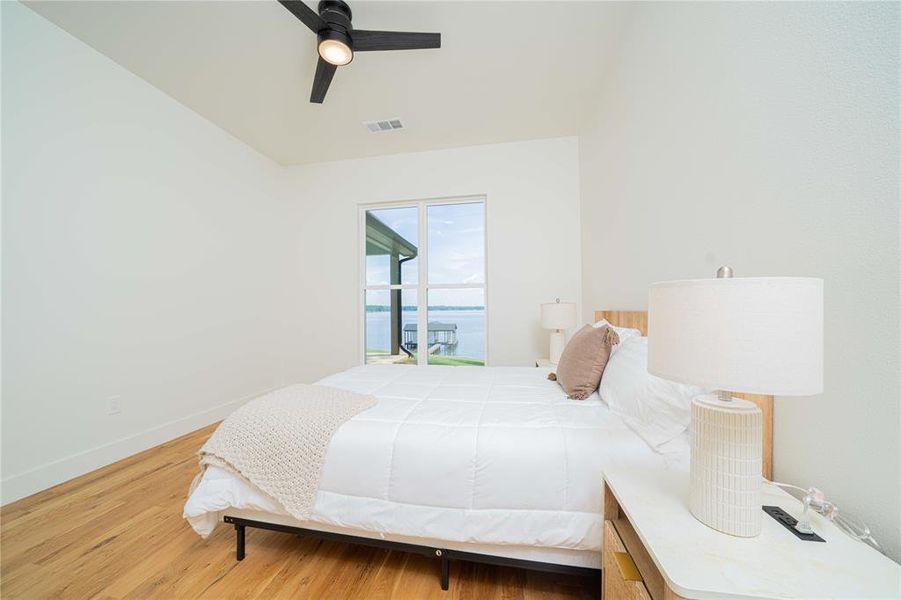 Bedroom with light wood finished floors, access to outside, and a ceiling fan Bedroom with light wood finished floors, access to outside, and a ceiling fan