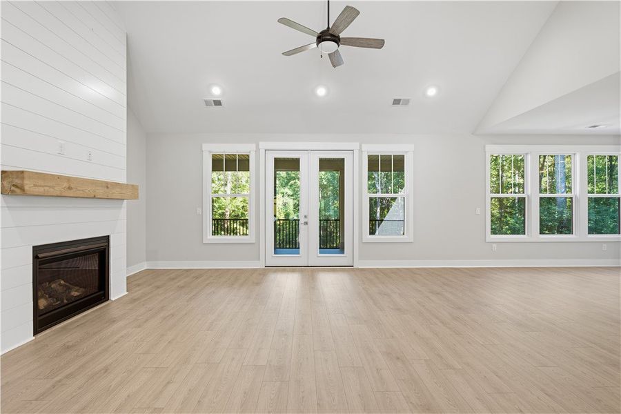 A spacious living room features vaulted ceilings,