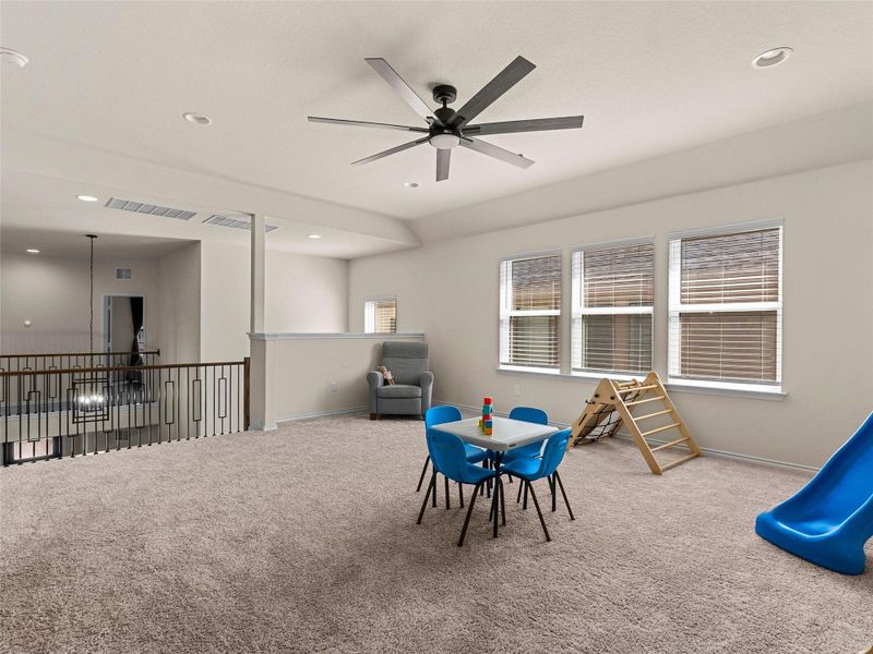 Recreation room with carpet floors, a ceiling fan, recessed lighting, and healthy amount of natural light