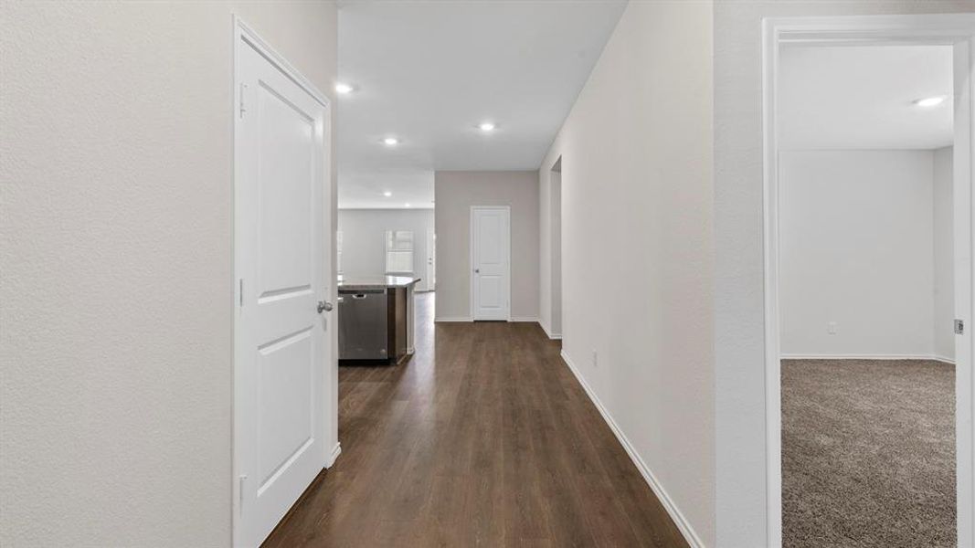 Corridor with recessed lighting and dark wood-type flooring