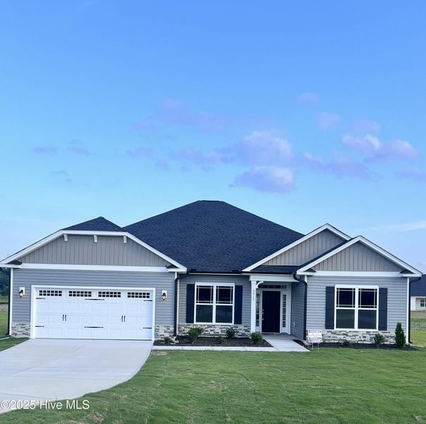 Front exterior of a new home in Magnolia Estates, Battleboro, NC, highlighting curb appeal (Image 1). Front exterior of a new home in Magnolia Estates, Battleboro, NC, highlighting curb appeal (Image 1).
