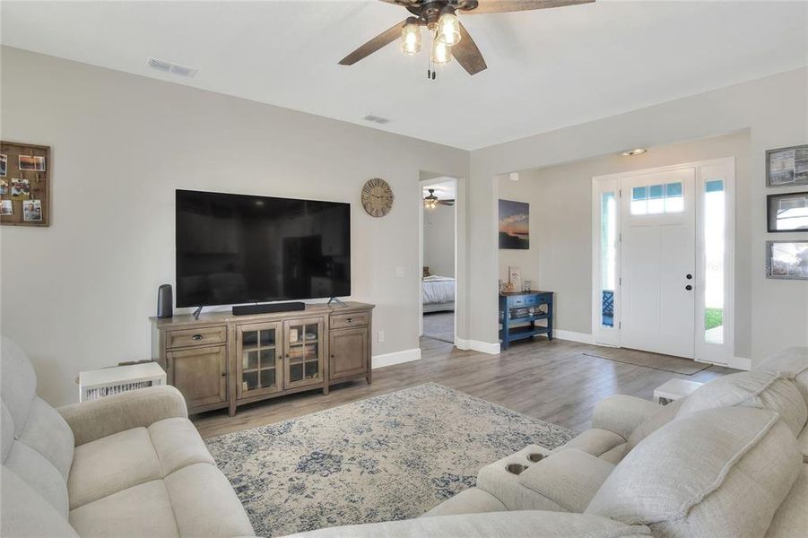 Front door and living area, hallway that leads to Bedrooms 2-4.