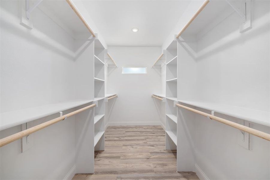 Spacious closet with light wood finished floors