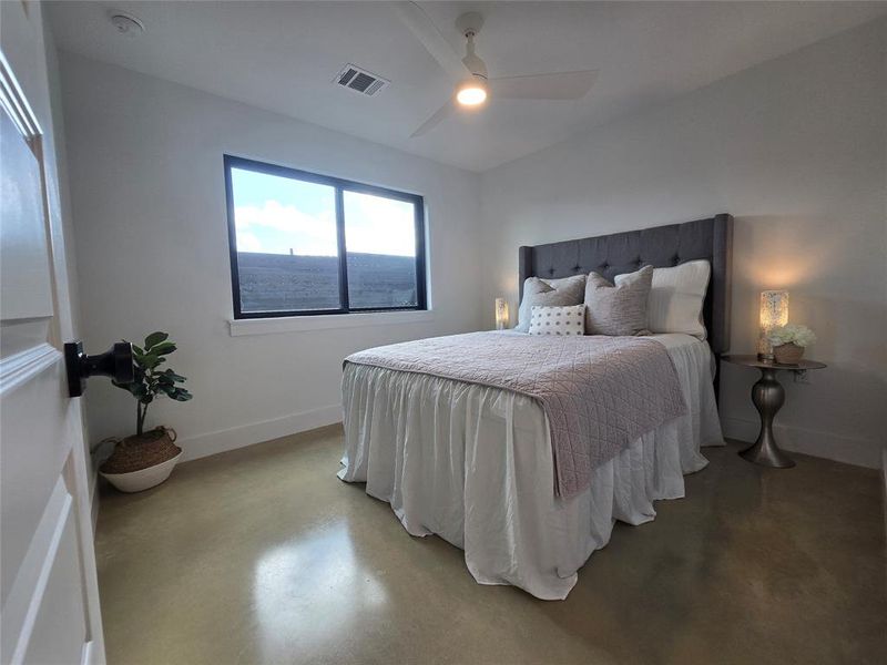 Downstairs bedroom with a large window to the back yard.