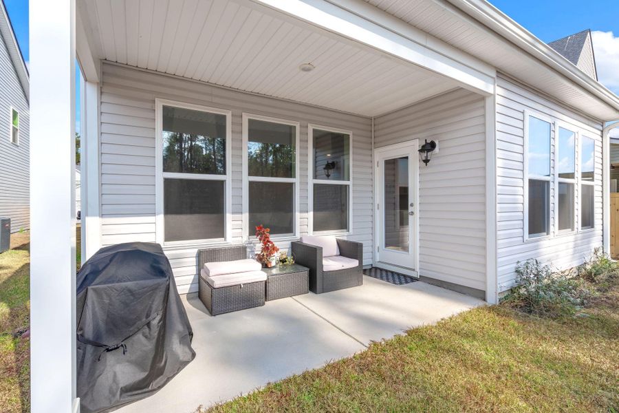 Exterior details and patio area of a home in Jasmine Point at Lakes of Cane Bay, Summerville (Image 26).