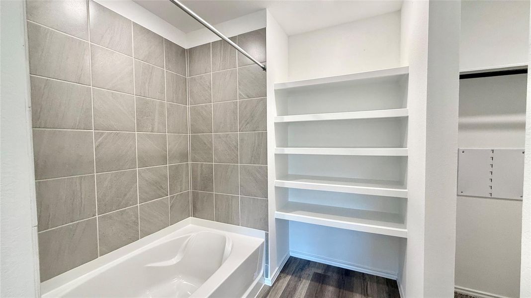 Easy-to-maintain tiled tub and shower surround.