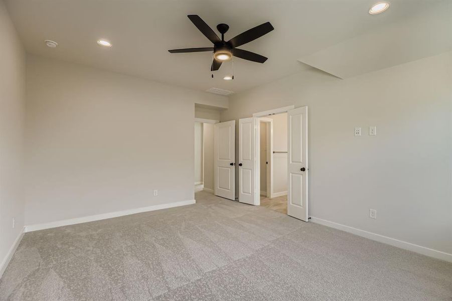 Unfurnished bedroom with light carpet, recessed lighting, and ceiling fan