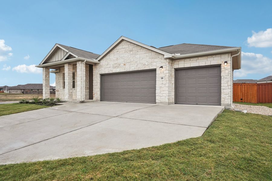 Front exterior of a new home in Crosswinds, Kyle, TX, highlighting curb appeal (Image 2). Front exterior of a new home in Crosswinds, Kyle, TX, highlighting curb appeal (Image 2).