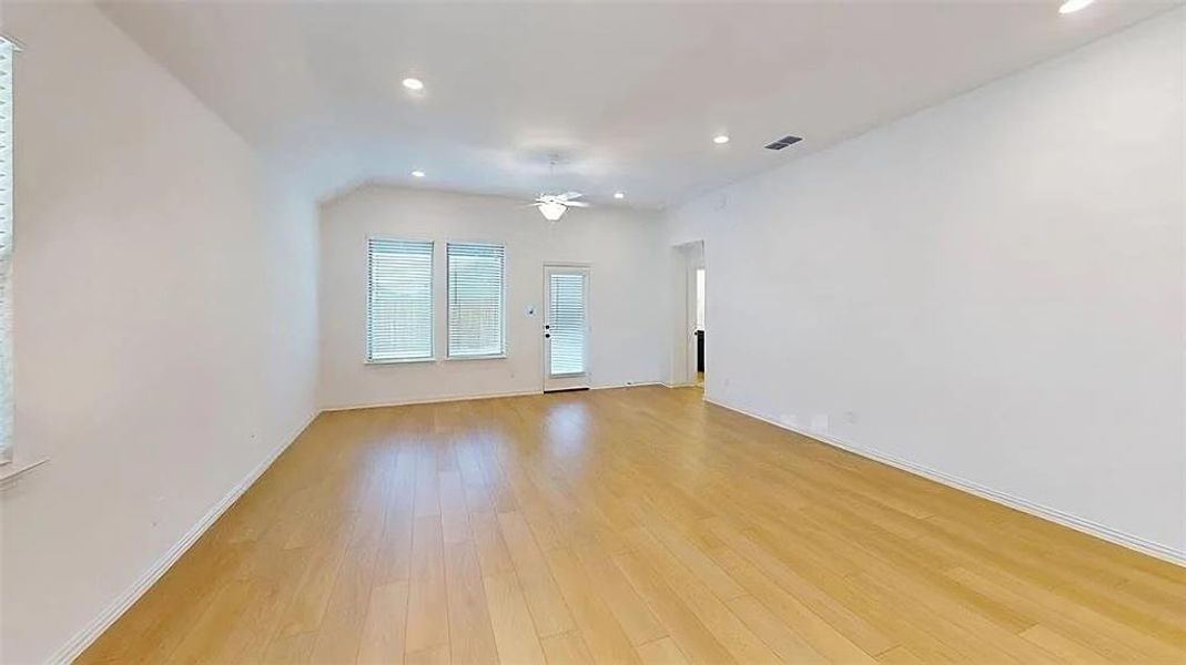 Empty room featuring light wood-type flooring and recessed lighting