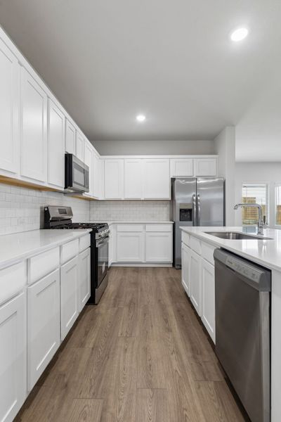Kitchen in the Oscar home plan by Trophy Signature Homes – REPRESENTATIVE PHOTO