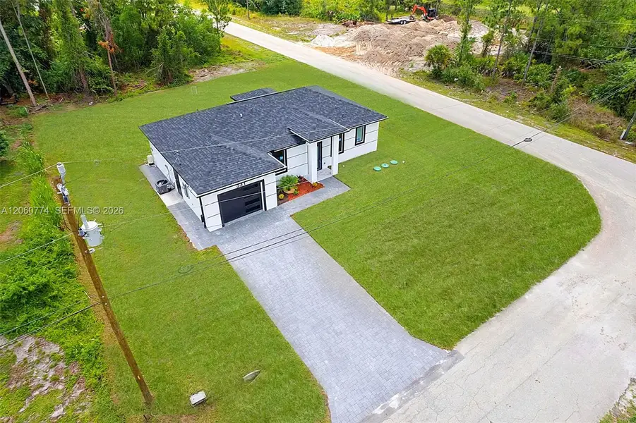 Front exterior of a new home in , Lehigh Acres, FL, highlighting curb appeal (Image 23). Front exterior of a new home in , Lehigh Acres, FL, highlighting curb appeal (Image 23).