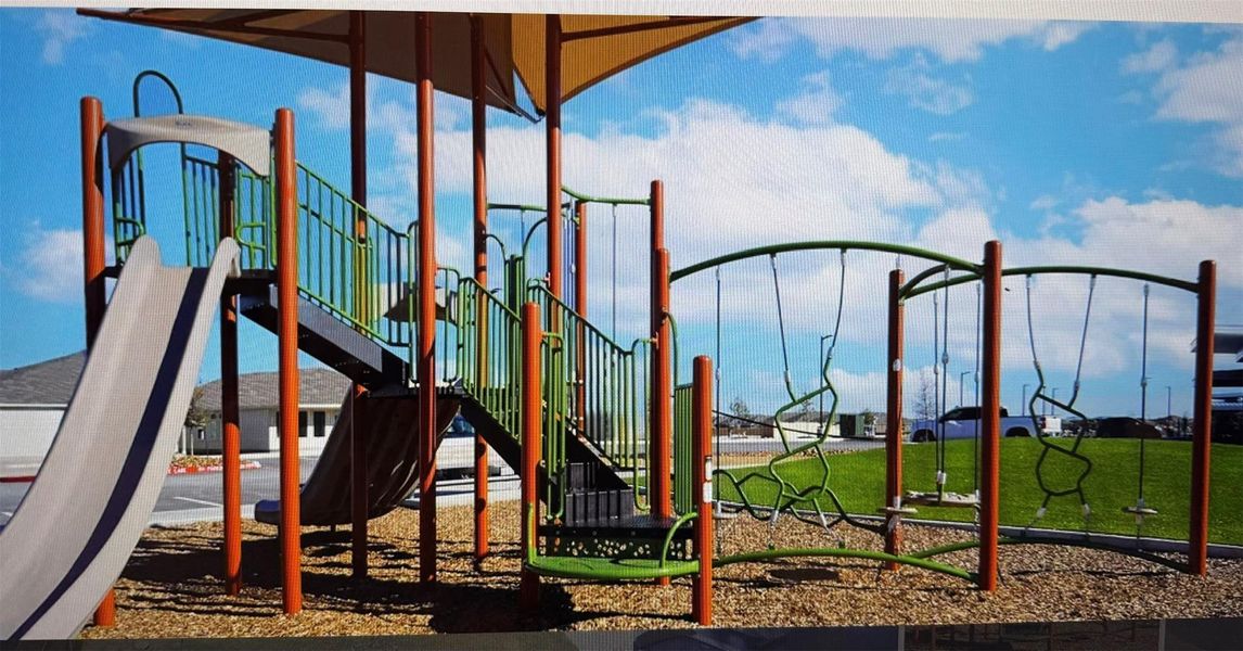 A vibrant playground structure offers recreation and leisure for all ages within the community.
