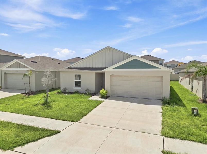 Front exterior of a new home in Forest Lake, Davenport, FL, highlighting curb appeal (Image 27).