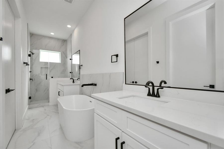 Enjoy the convenience of having an oasis for an ensuite bath featuring double sinks with large vanity, large soaking tub and a serene glass frame standing shower.