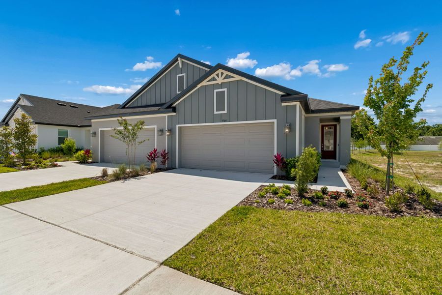 Front exterior of a new home in Fairway Pointe - Villa Community, Sun City Center, FL, highlighting curb appeal (Image 1). Front exterior of a new home in Fairway Pointe - Villa Community, Sun City Center, FL, highlighting curb appeal (Image 1).