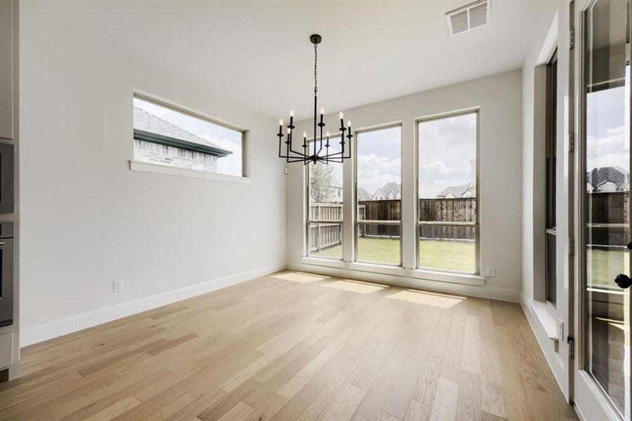Light wood-finish flooring complements the neutral wall tones Light wood-finish flooring complements the neutral wall tones