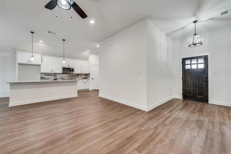 Entryway with light wood-type flooring, recessed lighting, a chandelier, and ceiling fan