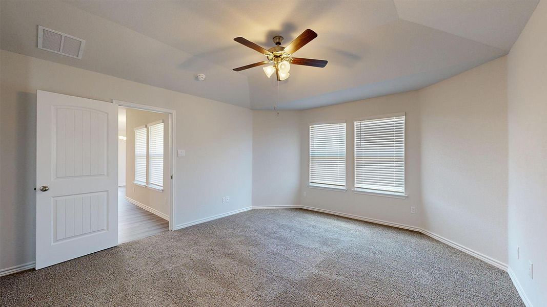 Empty room featuring carpet flooring and a ceiling fan Empty room featuring carpet flooring and a ceiling fan