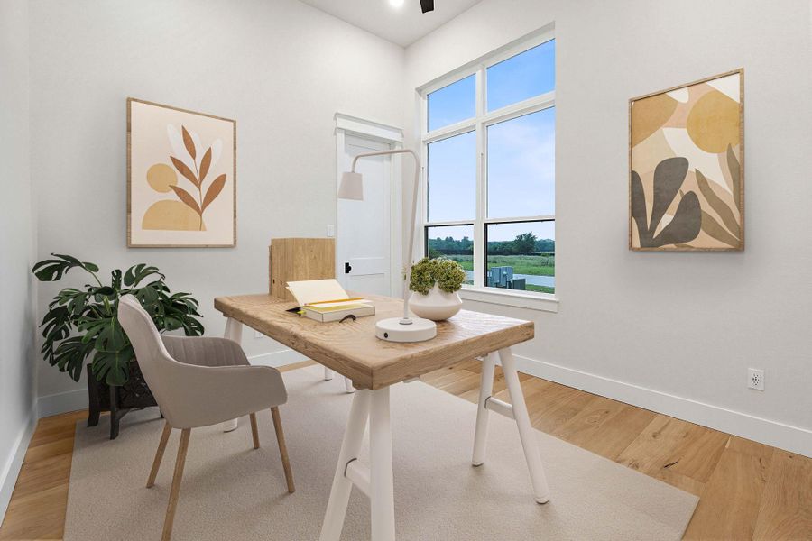 Bright room featuring a large multi-pane window, light wood-finish flooring, and white baseboards
